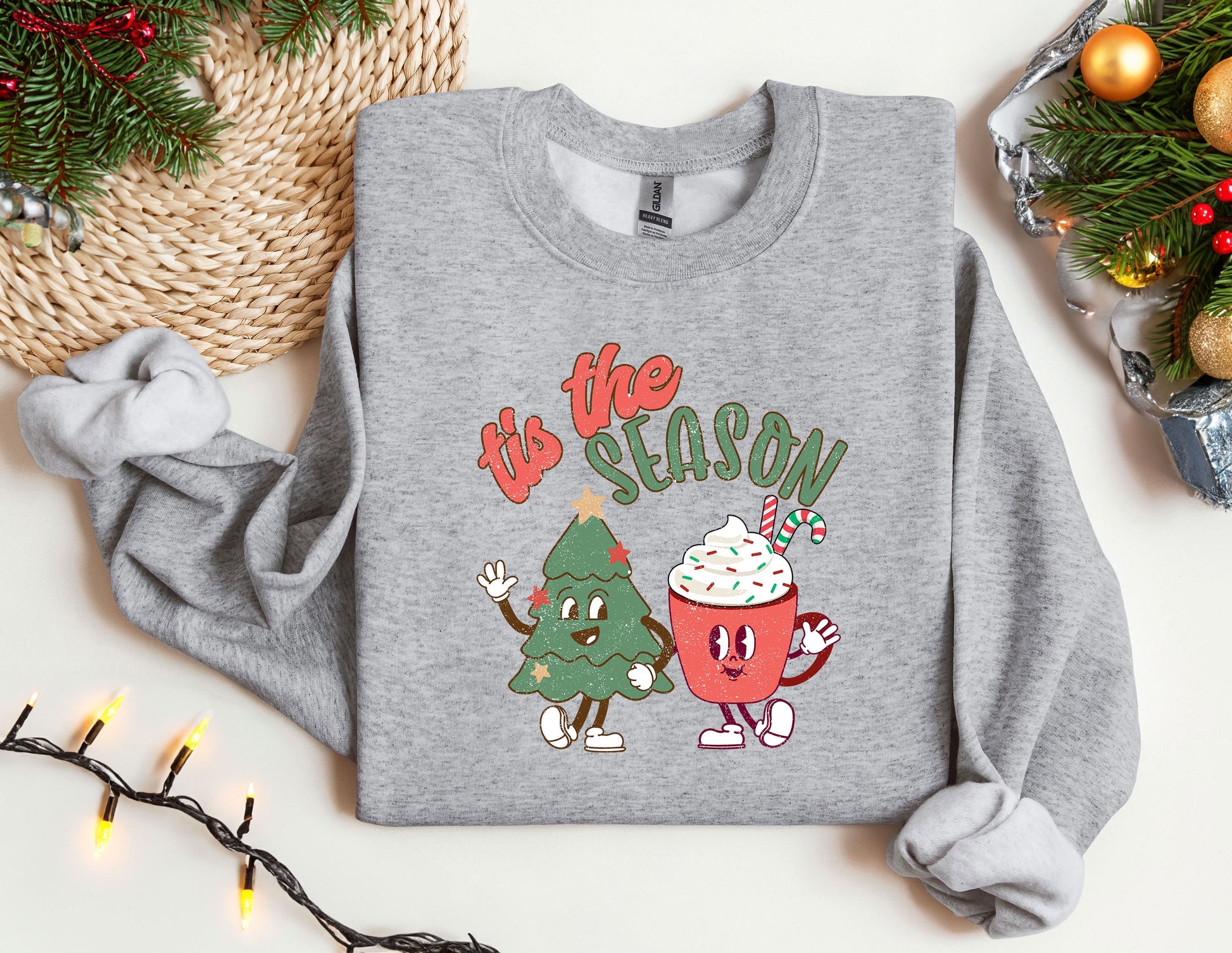 a sweater with a christmas tree and a cupcake on it