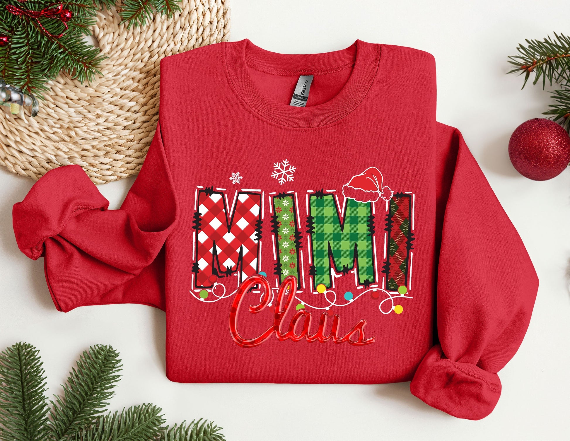 a red sweater with the word mimi claus on it