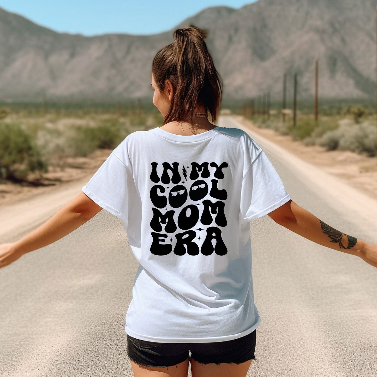 a woman walking down a road with her arms outstretched