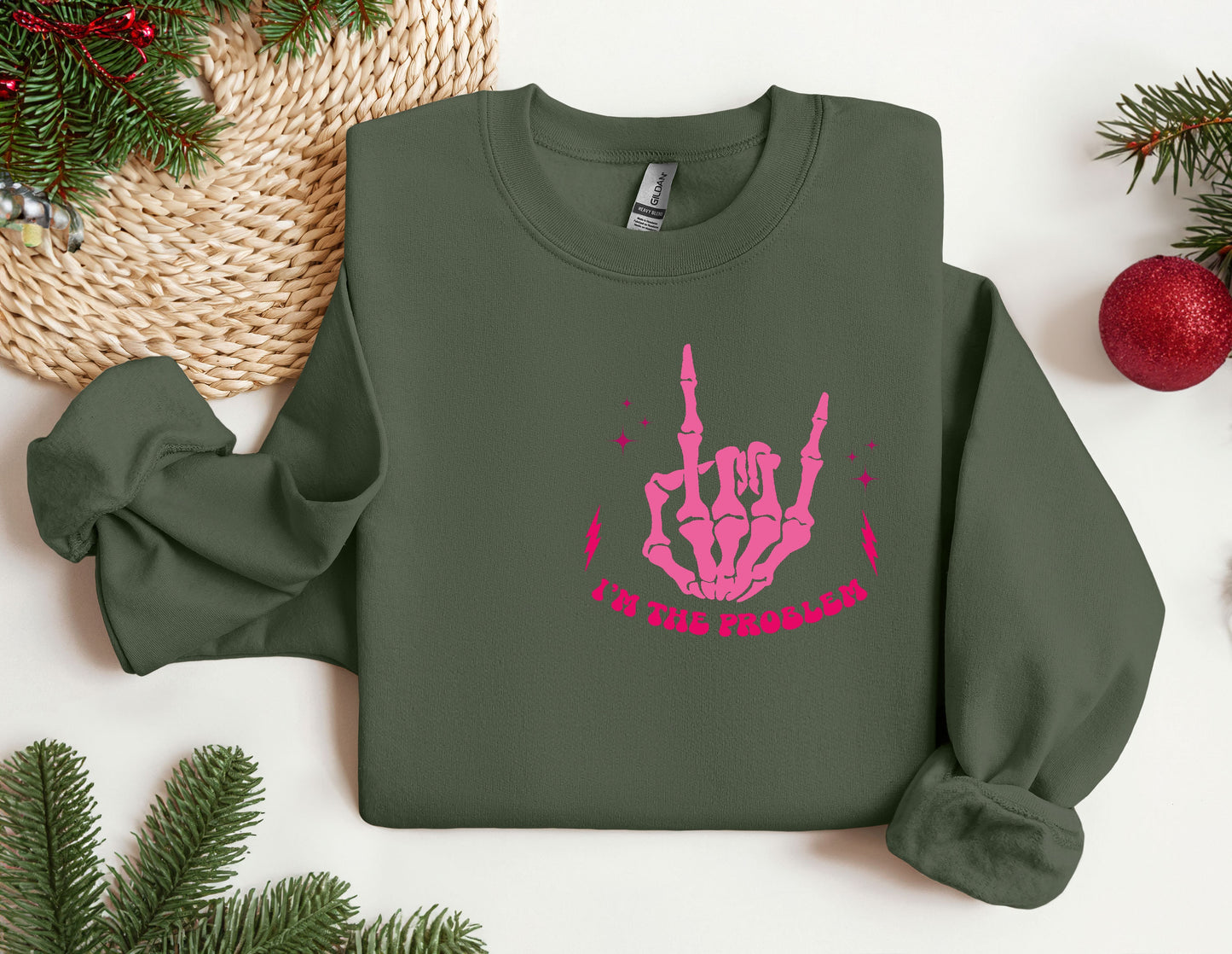 a green sweater with a pink hand print on it