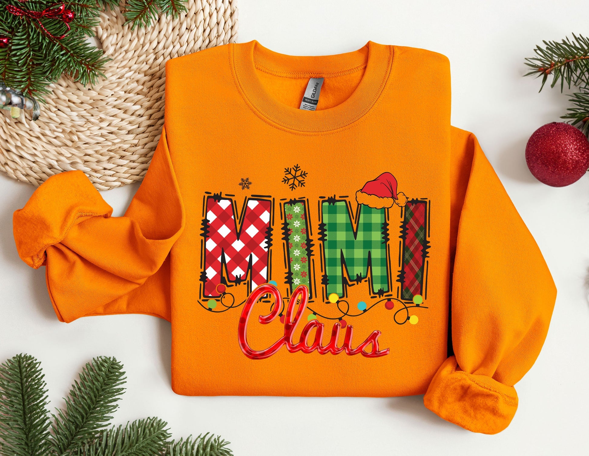 an orange shirt with the word mum claus on it
