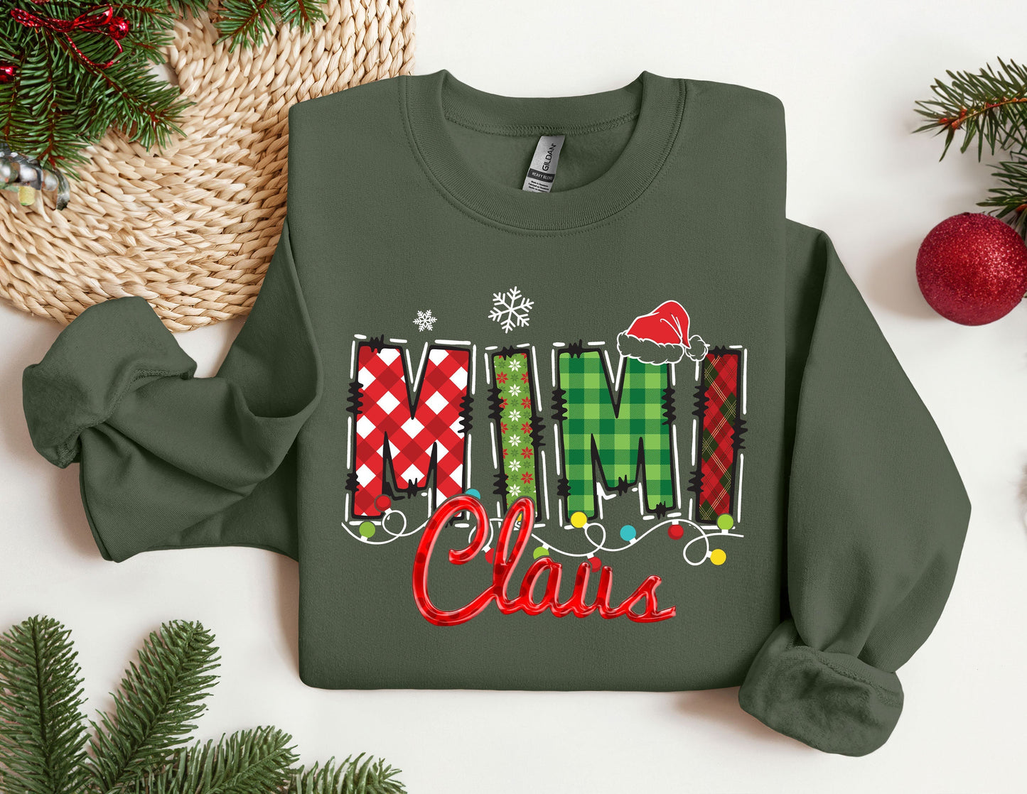 a green sweatshirt with the word mimi claus on it