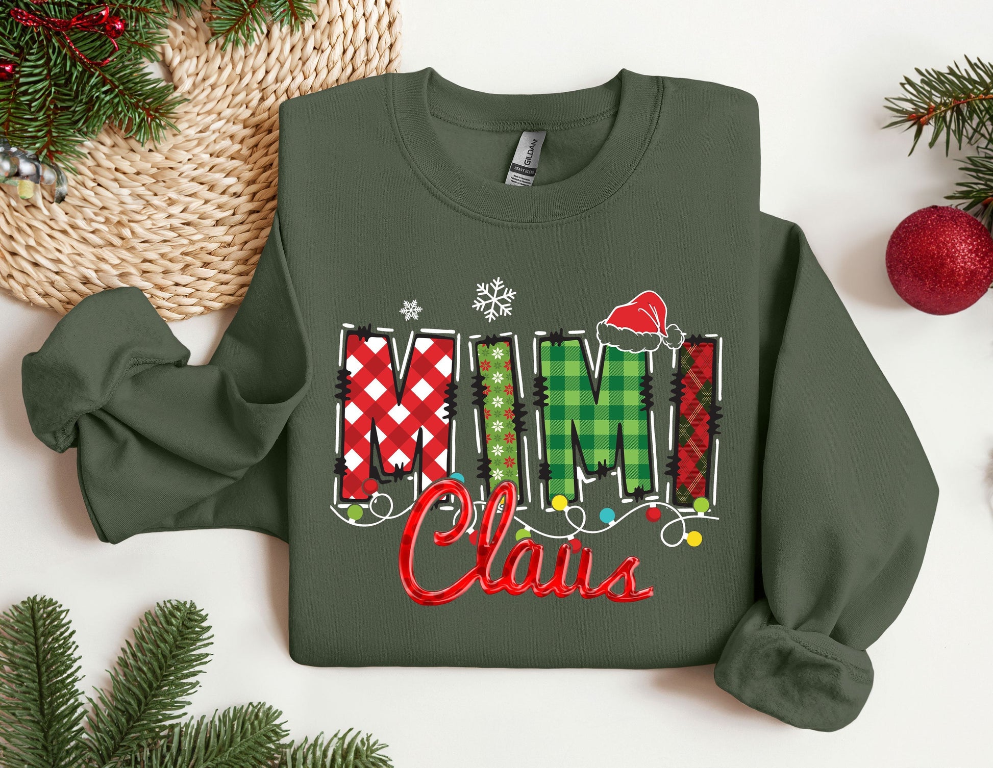 a green sweatshirt with the word mimi claus on it