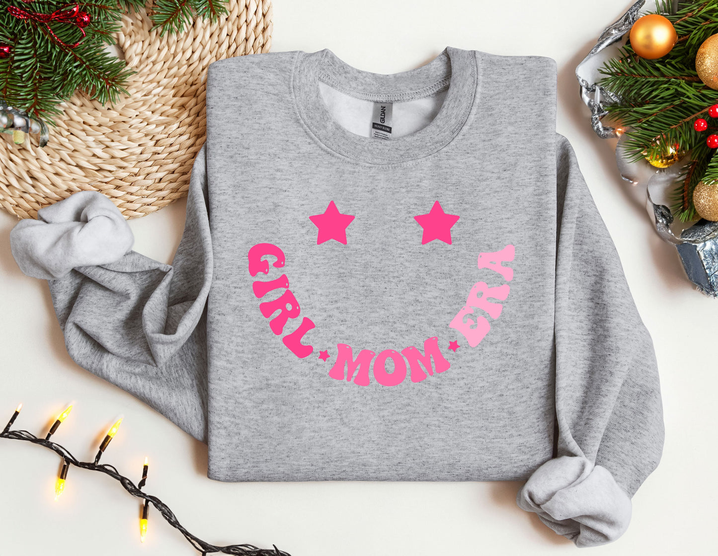 a gray sweatshirt with pink stars and the words stay mom on it