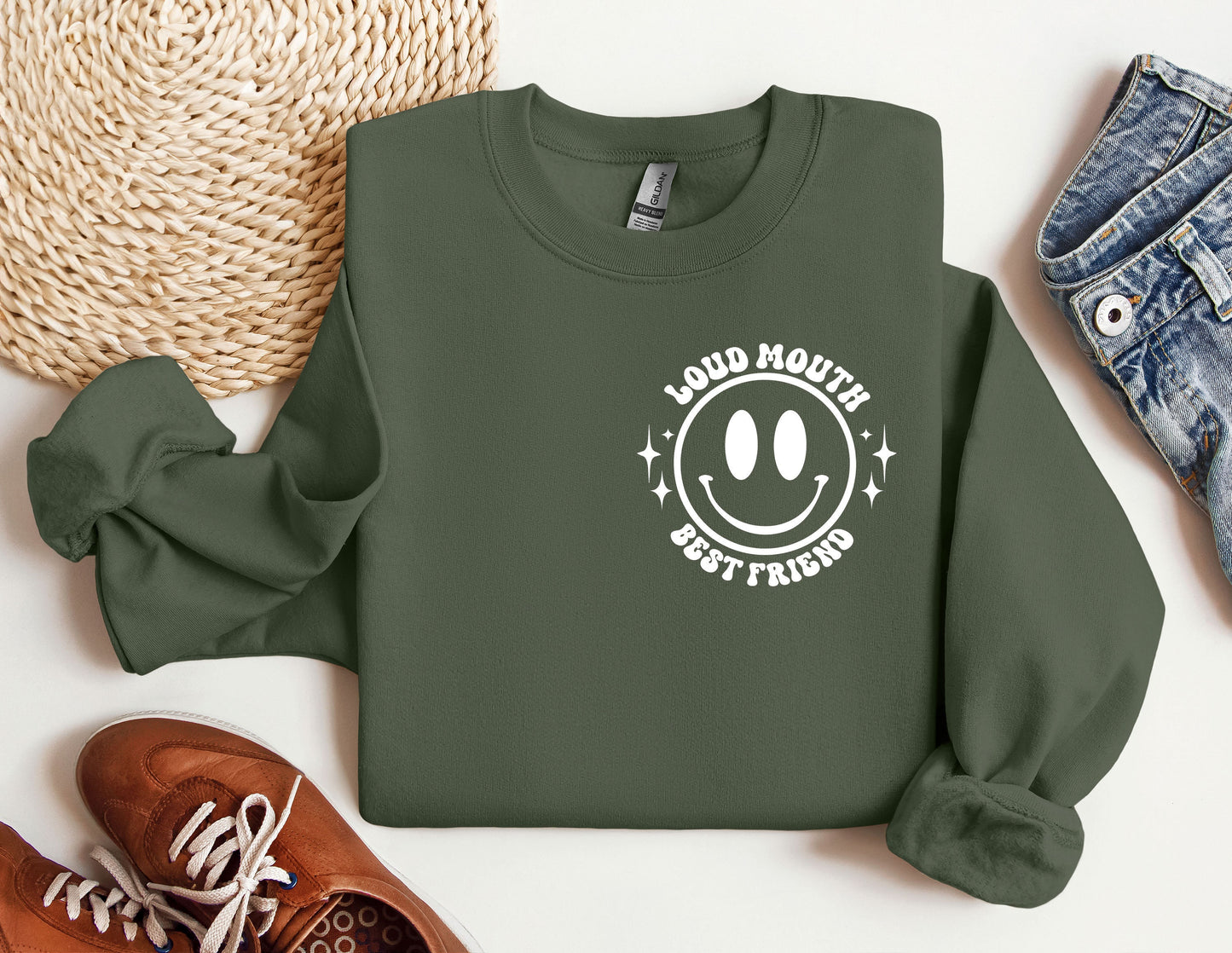 a green sweatshirt with a smiley face on it