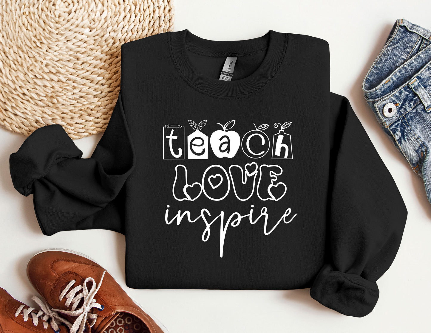 a black sweatshirt with the words teach love inspire on it